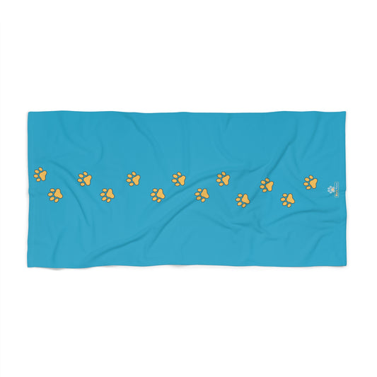 Blue towel with yellow paw prints 